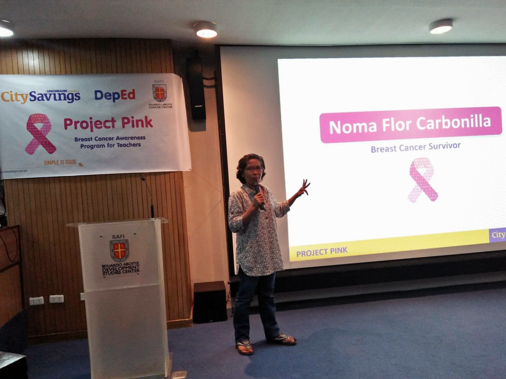 PROJECT PINK: Breast cancer survivor Noma Carbonilla speaks to an audience of teachers during CitySavings Project Pink in Cebu City.