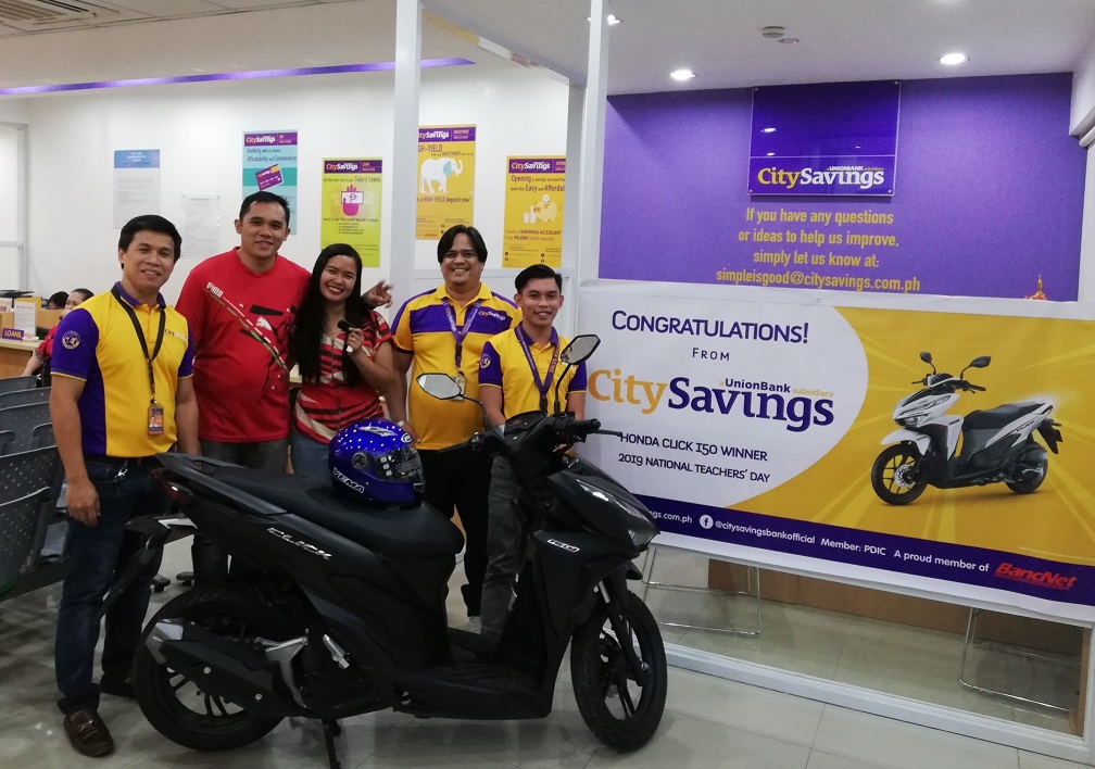 TEACHER TREATS: The winner of the brand new Honda Click Motorcycle happily receives her prize - Charmyne Tumala of Tangub City Central School