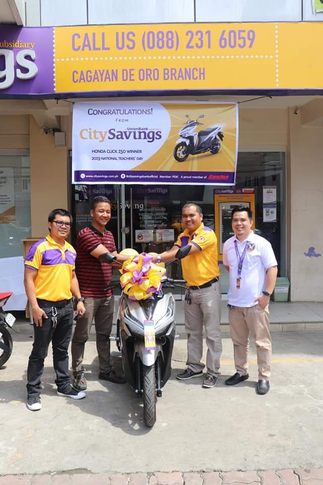 TEACHER TREATS: The winner of the brand new Honda Click Motorcycle happily receives his prize - Odelio Ramoso of San Luis National High School, Gingoog City, Misamis Oriental.
