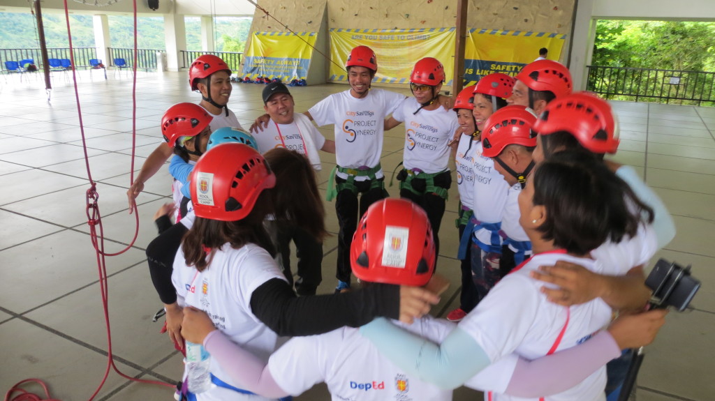 FOSTERING TEAMWORK: Project Synergy participants from DepEd Region 11 celebrate their triumph over the rope courses and challenges at RAFI KAC, Balamban, Cebu.