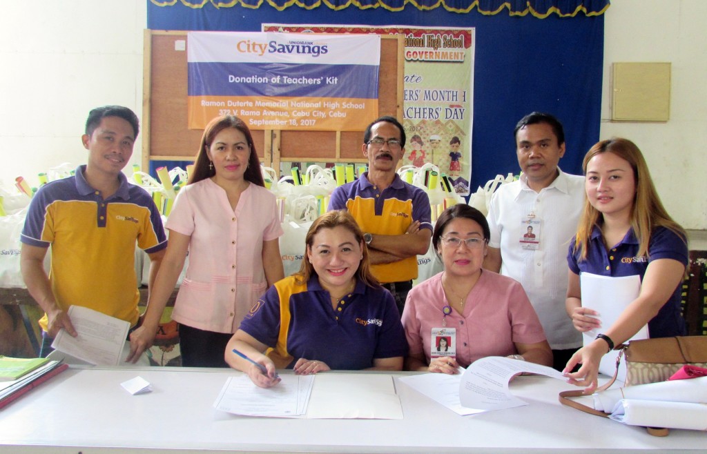 TEACHING KITS: Representatives from City Savings Bank led by Reputation Management Head Paula Ruelan (seated, left) and Branch Business Head Sedrick Sesante (standing, 3rd from left) and Ramon Duterte Memorial National High School headed by Principal Eileen Irina Tayactac, during the Memorandum of Agreement signing last September 18.