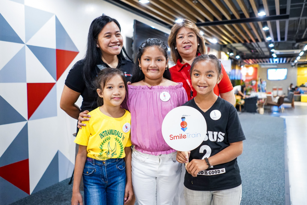 Smile Train Area Director Kimmy Flaviano and Aboitiz Foundation COO Maribeth Marasigan with Cheska and fellow Smile Train kids.