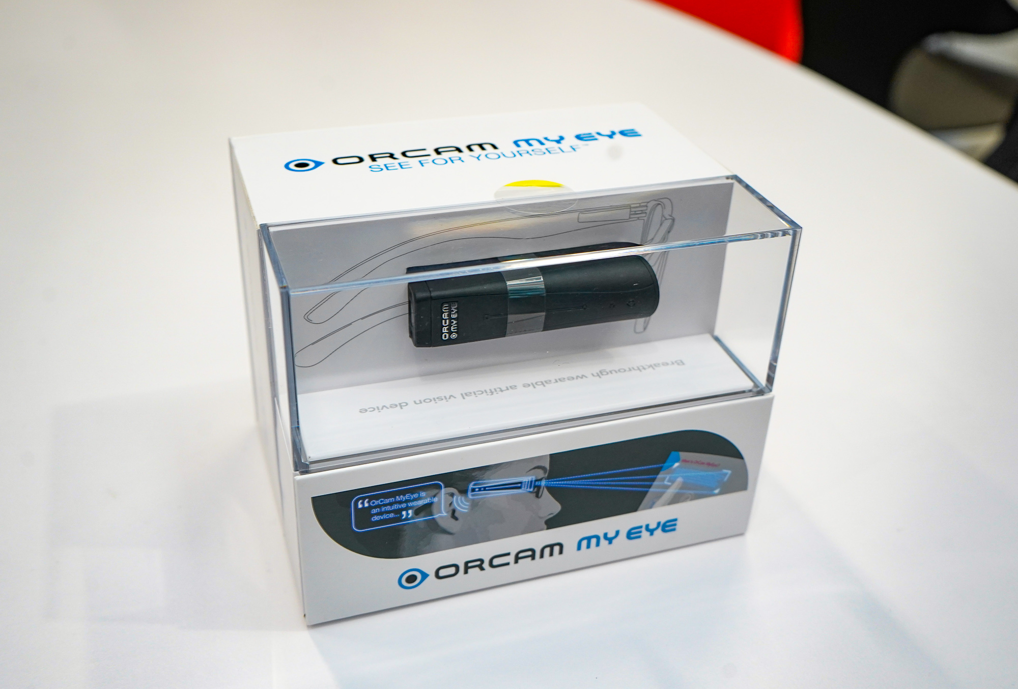 An OrCam MyEye 2.0 device, which has intuitive features that help a visually-impaired user read printed and digital text aloud, among other features.