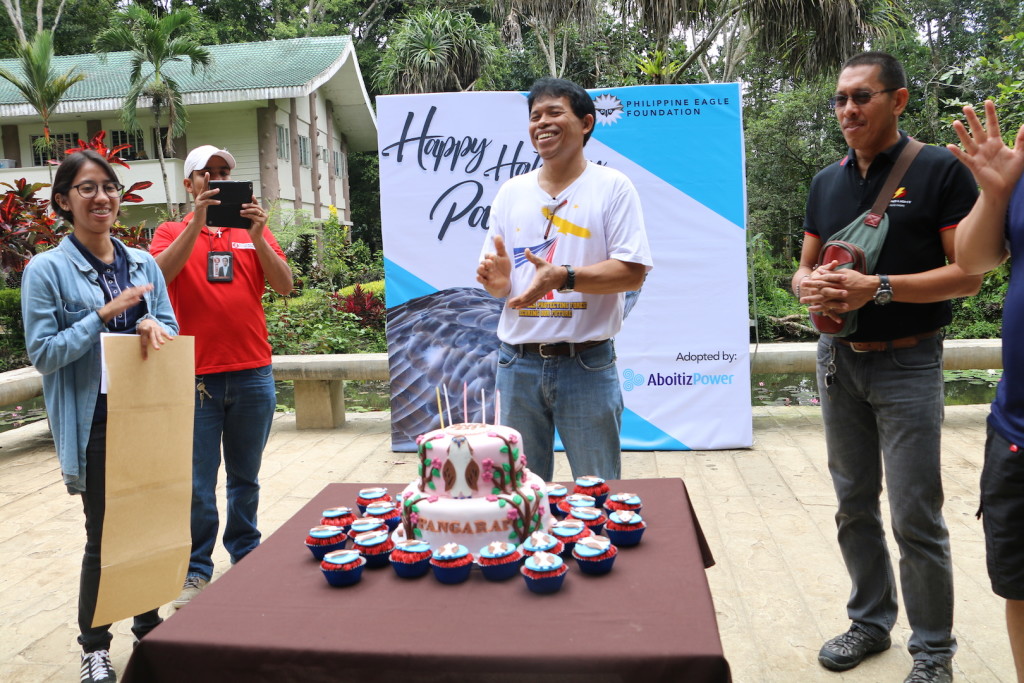 FOR KEEPS. Eagle Pangarap’s keeper Manong Eddie (center) is all smiles as he sings a birthday song for the 19-year-old female Philippine Eagle. Manong Eddie has been with the Philippine Eagle Foundation for 31 years now and has been with Pangarap since she was a chick.