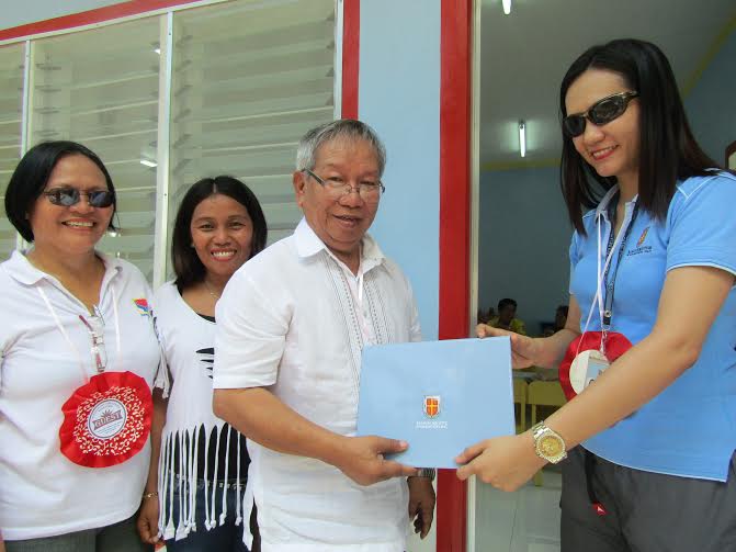 NEW SCHOOL YEAR, NEW CLASSROOM. Barangay Captain Aquiles Gatcho of Malolos in Barili town (third from left) receives the certificate of turnover from RAFI-DACF Executive Director Iris Andrino.