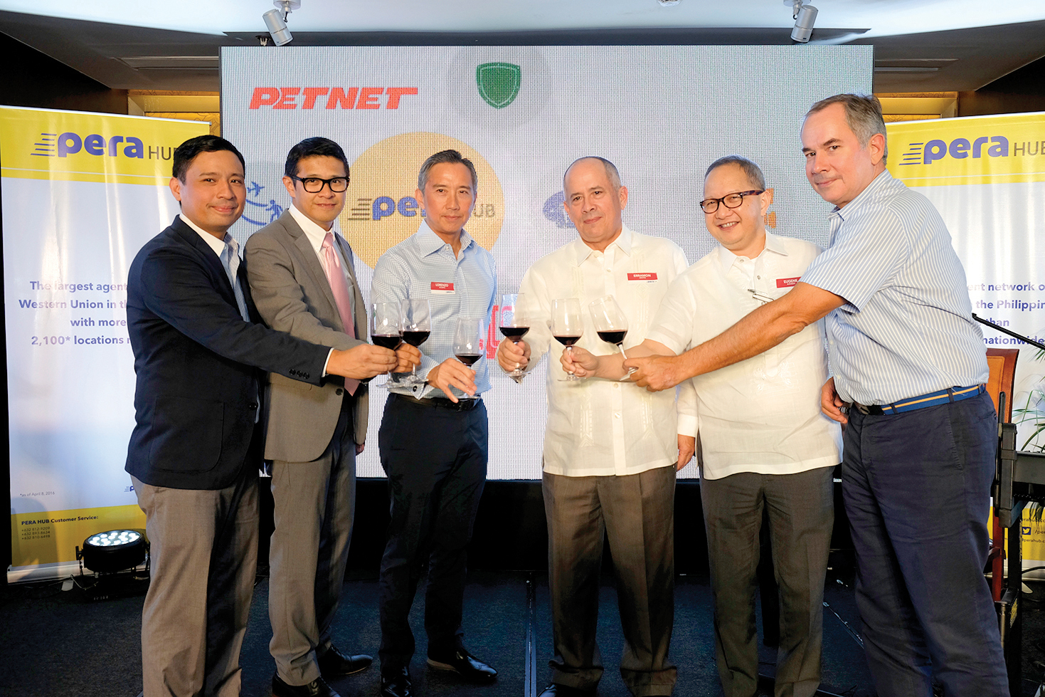 FASTER AND BETTER. AEV President and CEO Erramon Aboitiz (fourth from left) and AEV EVP and COO Sabin Aboitiz (farthest right) lead the ceremonial toast at the unveiling of the new PERA HUB brand with (from left) PETNET VP for Marketing and Auxiliary Services Ian Ocampo, Western Union Business Development Director Jeffrey Navarro, PETNET President Larry Ocampo, and City Savings Bank Chairman Eugene Acevedo.