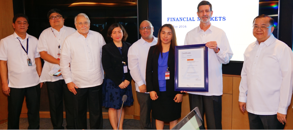 Edwin Bautista (far right) with current CEO Justo Ortiz (second from right) during the Bank's receipt of its ISO 9001:2015 standard. Also present in the photo is AEV Chairman Jon Ramon Aboitiz (third from left).