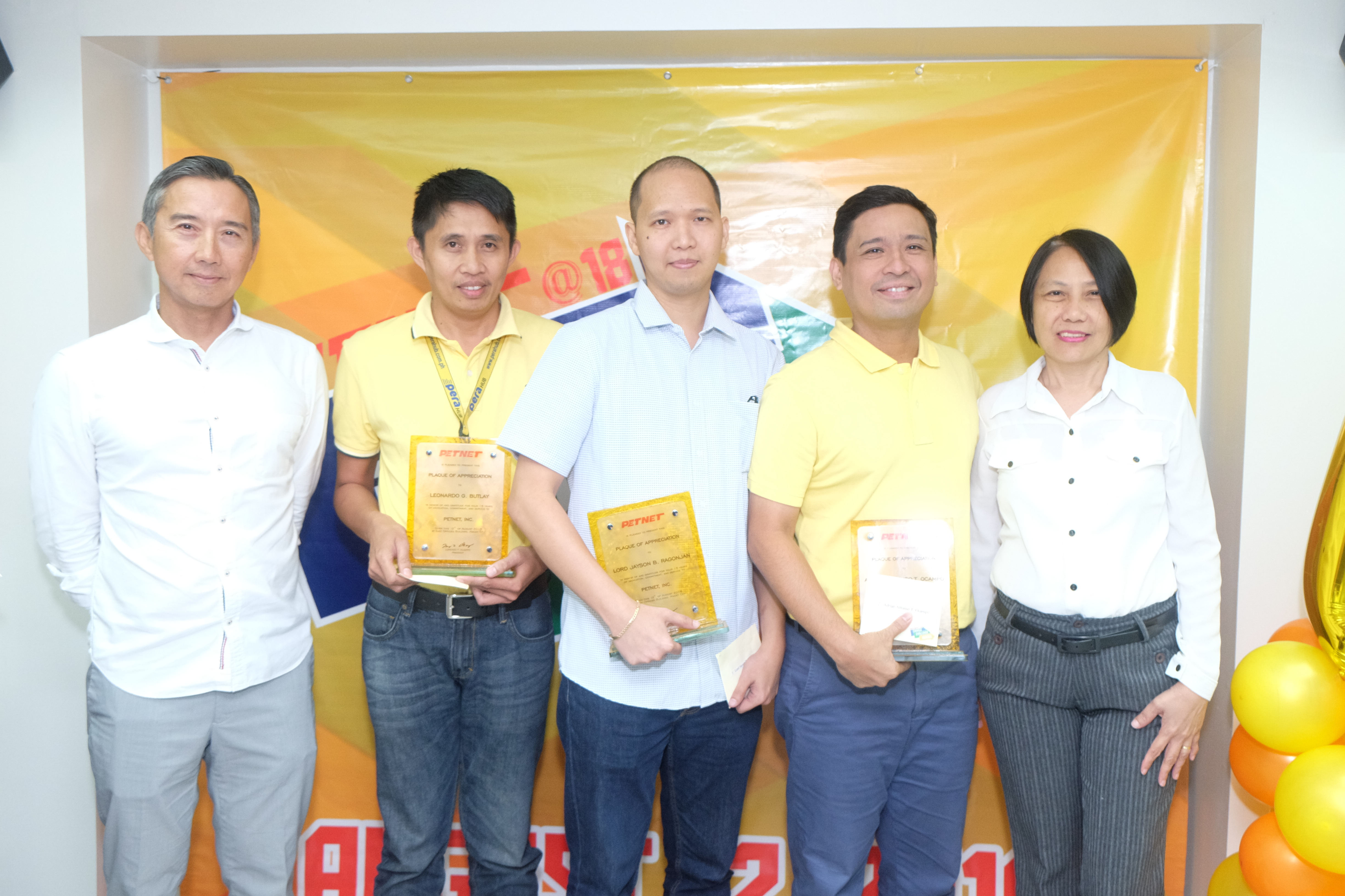 15 YEARS IN SERVICE. L-R: PETNET President Larry Ocampo and (Chris to supply name) hand out plaques of recognition to the 15-year service awardees Leonardo Butlay, Lord Jayson Ragonjan and Ian Ocampo, who is also the VP for Marketing and Auxiliary Services.