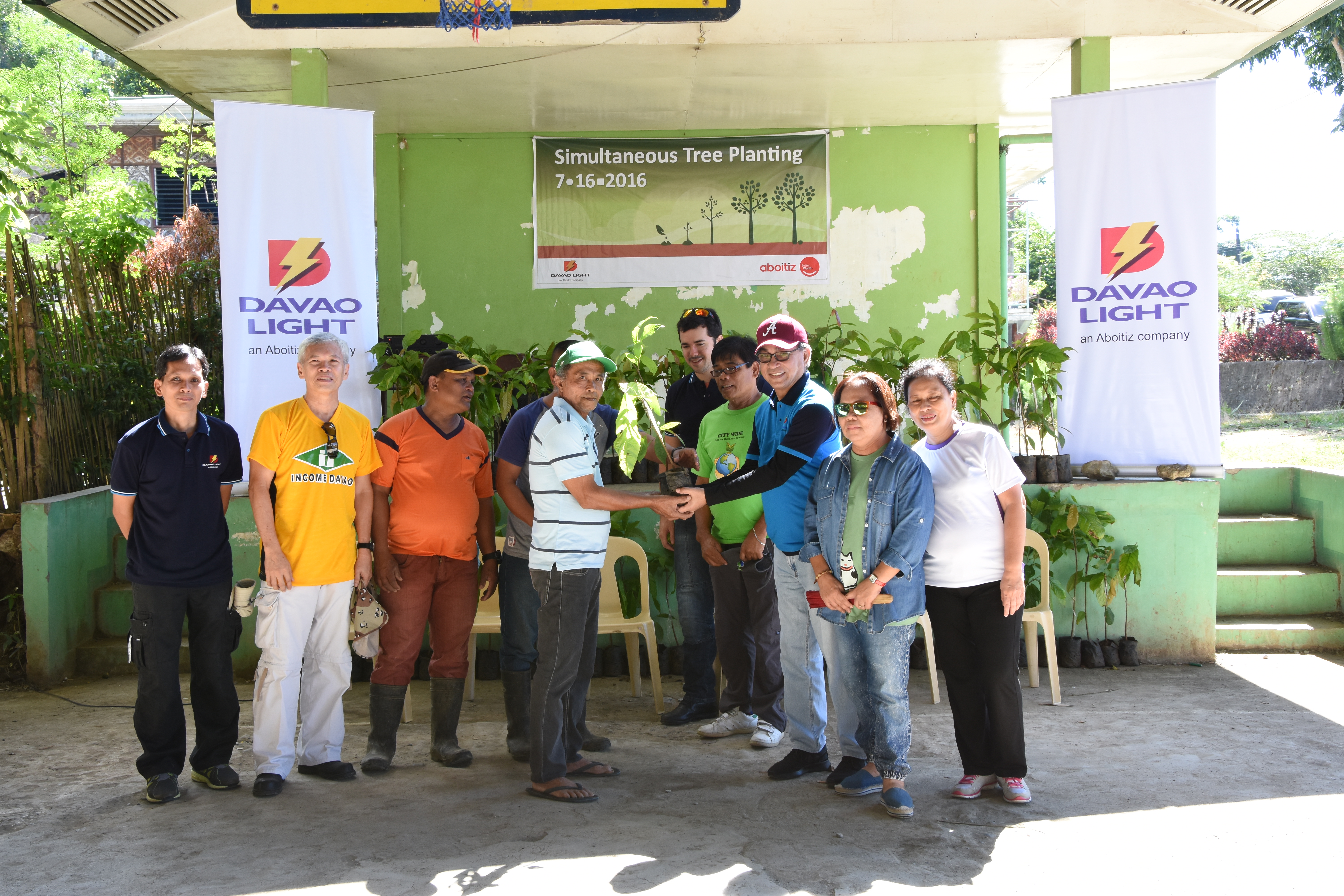 HANDOVER OF SEEDLINGS TO PARTNERS. Davao Light and Power Co. in partnership with the INCOME Credit Cooperatives turned over 2,100 cacao seedlings to Upper Kibalang Agro Forestry Association (UKAFA). UKAFA is Davao Light's partner in Upper Kibalang that helps ensures the survival of the planted seedlings. (L-R): Reputation Enhancement Manager Fermin Edillon, INCOME Credit Cooperatives General Manager Eduardo Tan, UKAFA President Emiliano Payusan, UKAFA Chairman of the Board Emeliano Payotes, Pilmico National Logistics Manager Jokin Aboitiz, DENR Region XI representative Efren Amaleja, Davao Light EVP and COO Arturo M. Milan, City ENRO Head Engr. Elisa P. Madrazo and Acting Manager of Bangko Sentral ng Pilipinas Lorna M. Salandanan.