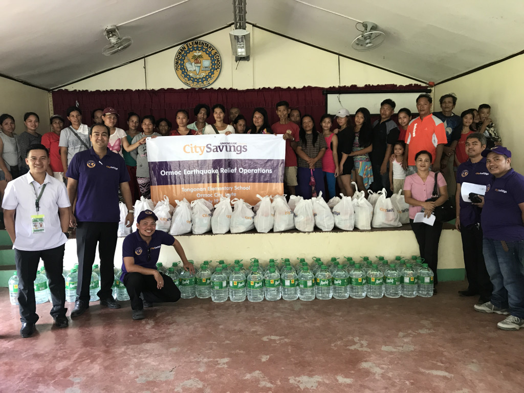 EXTENDING A HELPING HAND: Team members of CitySavings Ormoc Branch spearhead the relief operations at Tongonan Elementary School.