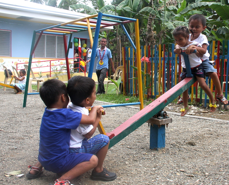 A SMALL WORLD AFTER ALL. Children of Tag-amakan, Asturias, Cebu enjoy their new playground that came with their new day care center.